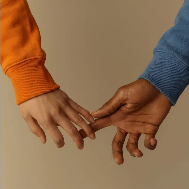 Two hands reaching for each other
